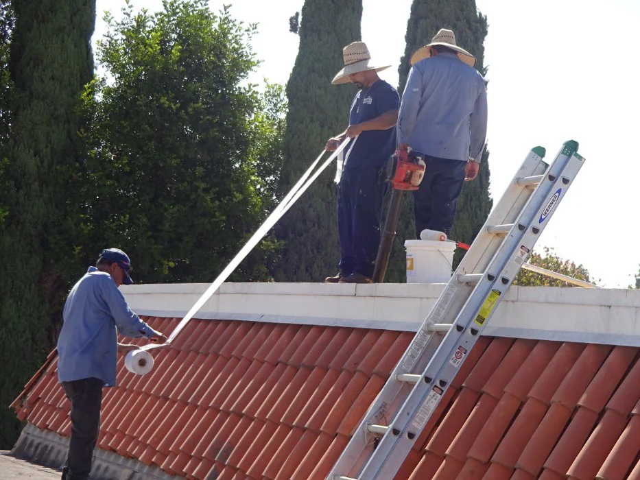 Roofing crew working on a residential roof in Los Angeles County, California, during an active roofing project
