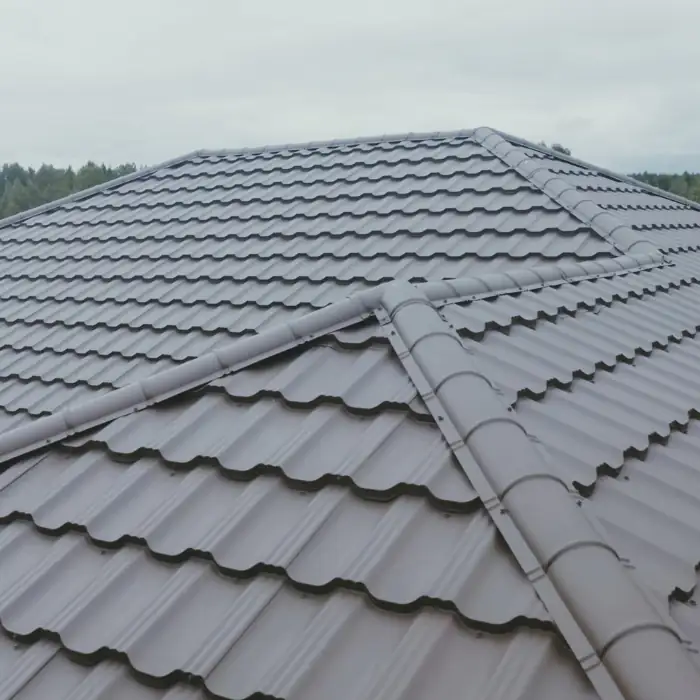 Elevated view of a gray metal rooftop in Orange County, California, highlighting sleek metal panels and a well-kept residential area