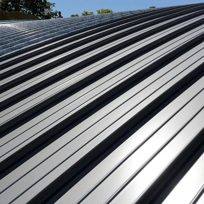 Shiny metal roof panels reflect sunlight on a home in Orange County, California, adding a clean and modern finish