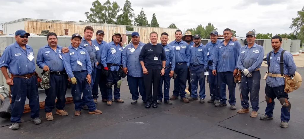 The Royal Roofing team stands together on a Southern California job site, ready to handle residential and commercial roofing work